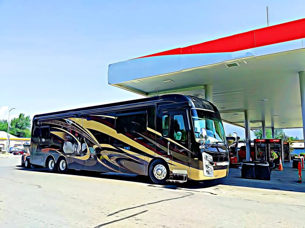 This is a black class A motor home receiving gas at the gasoline station.