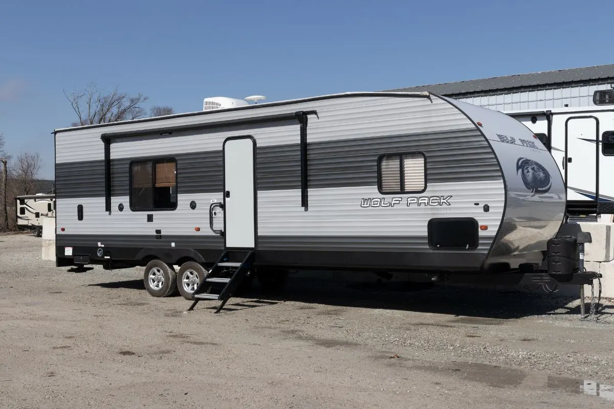 Side view of Fifth wheel RV standby in an asphalt area.