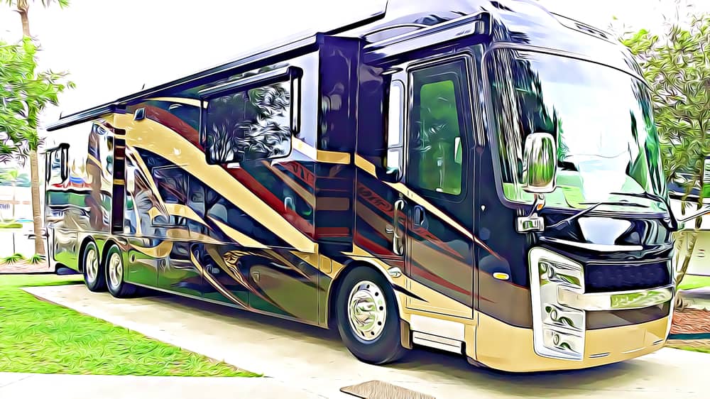 This is a close look at a Class A Motorhome parked at a concrete parking lot.