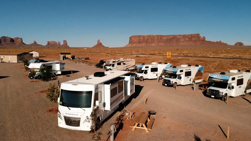 A bunch of RVs parked at a camping ground.