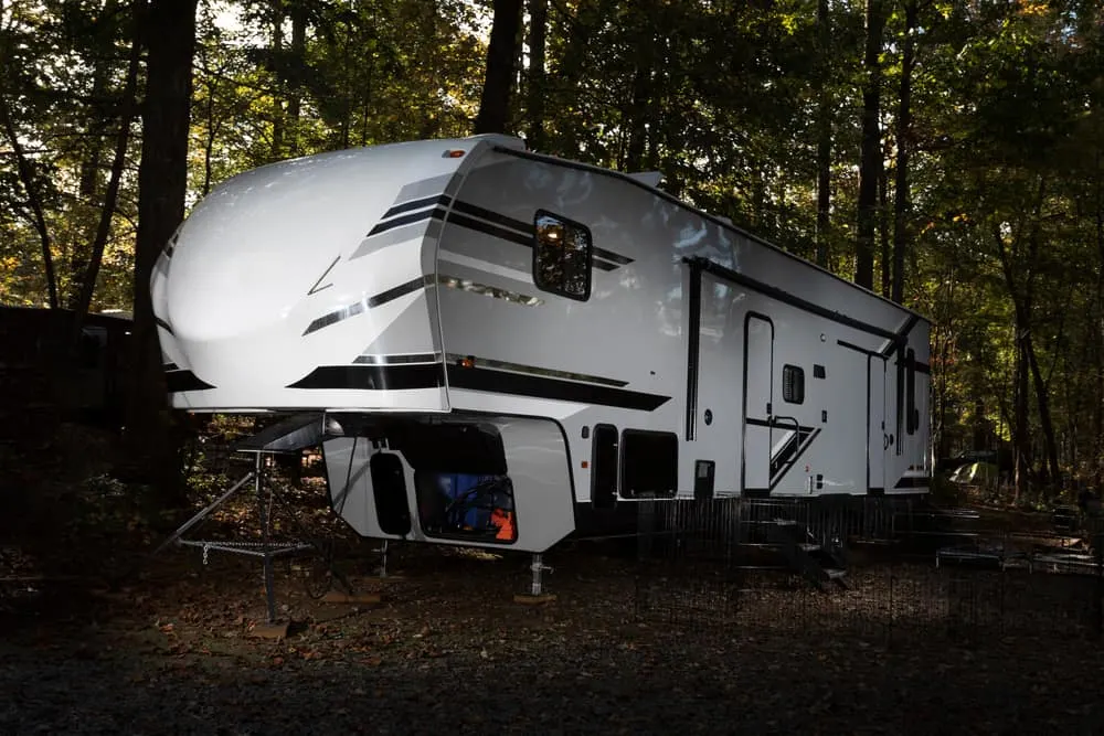 This is a fifth wheel camper towable RV parked at a camping site.