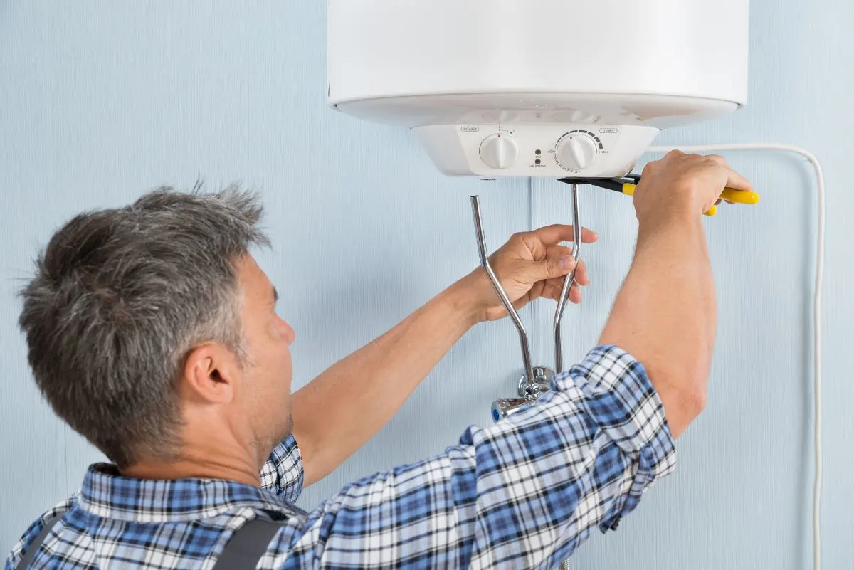 A plumber fixing water heater.