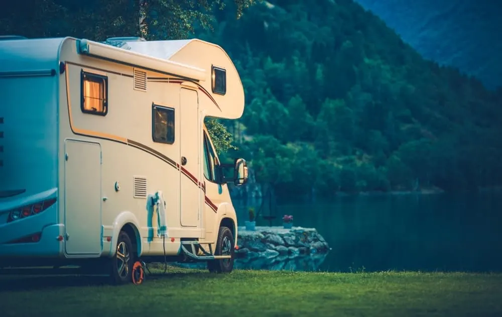 Motorhome parked near a stunning lake view.