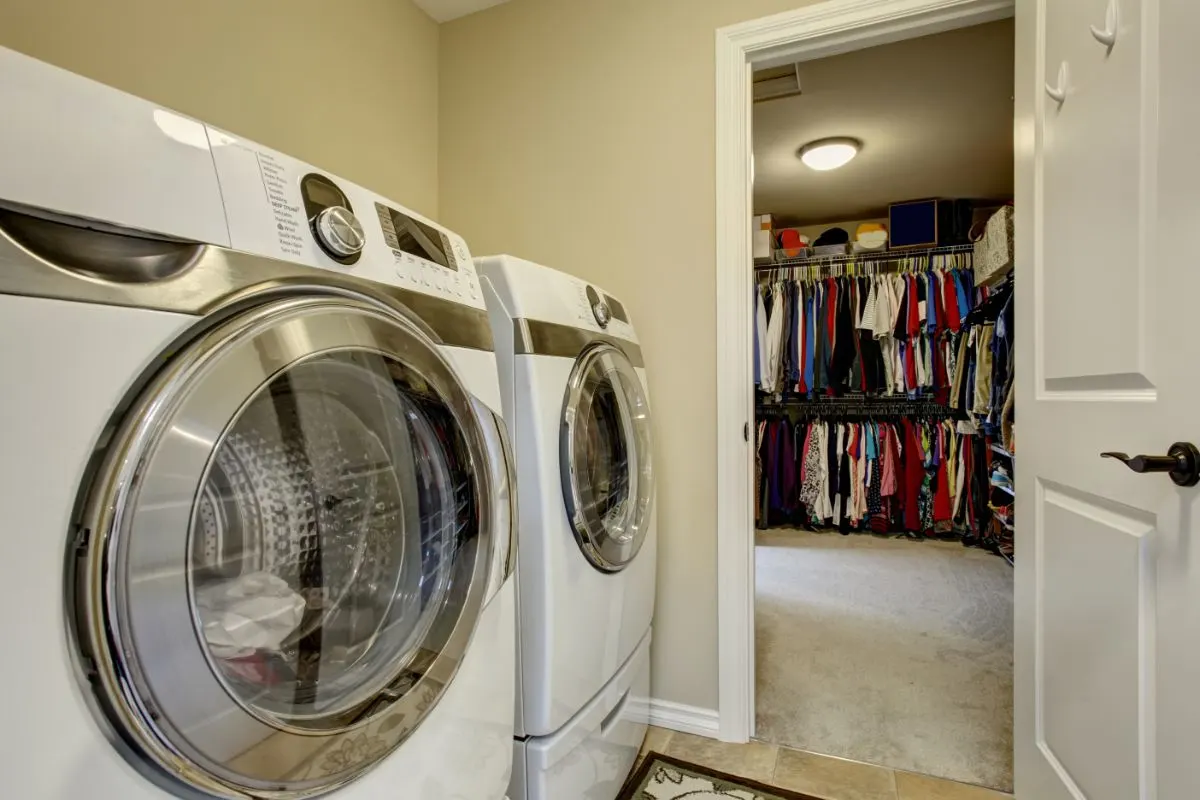 A photo of a room for laudry and a closet.