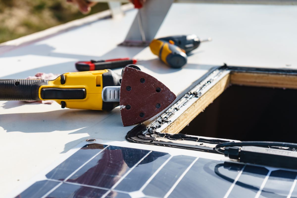 Close up photo of a solar panel and a broken sunroof.