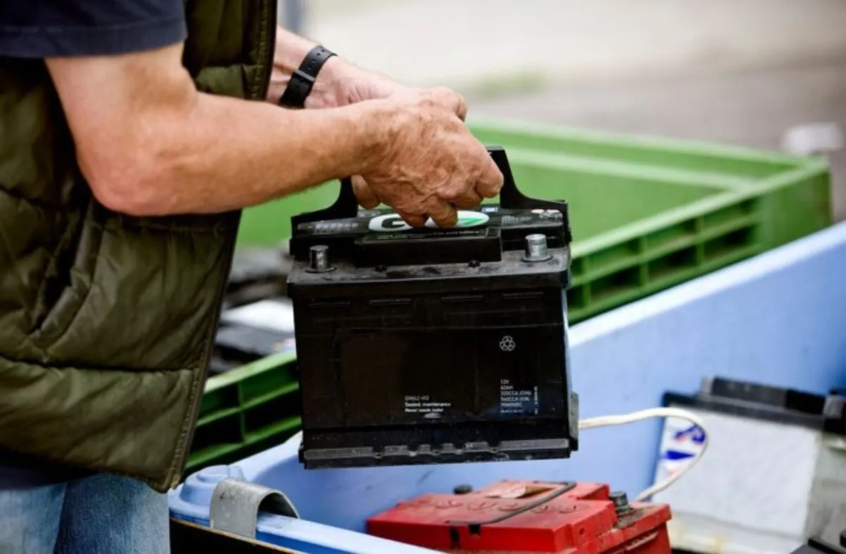 A man holding a battery for RV.