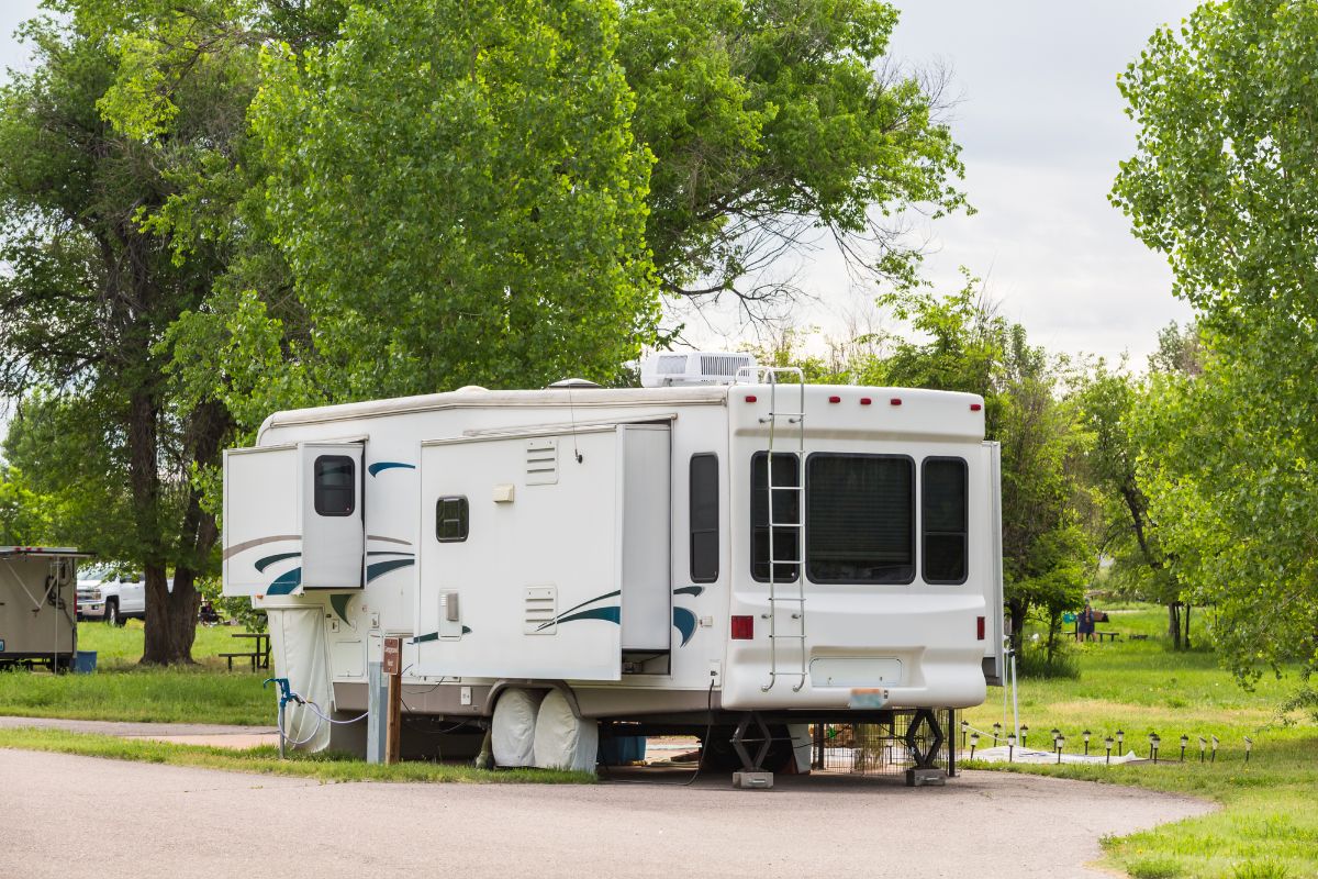 An RV on parked on camp site.