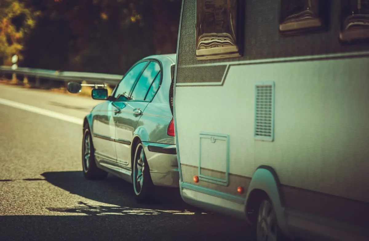 Compact car towing RV.