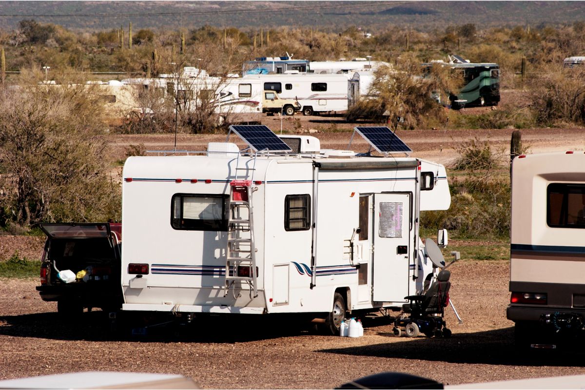 A photo of recreational vehicles in a desert place for a camp.