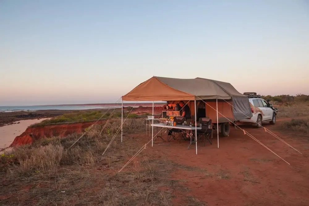 Tent camper set up on a clifftop with stunning ocean views.