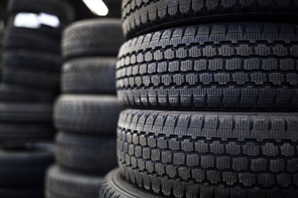 A photo of stacks of tires in tire store.