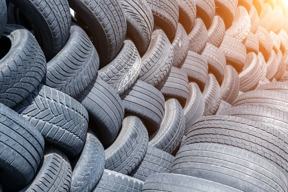 A photo of old used weared car and truck wheels.