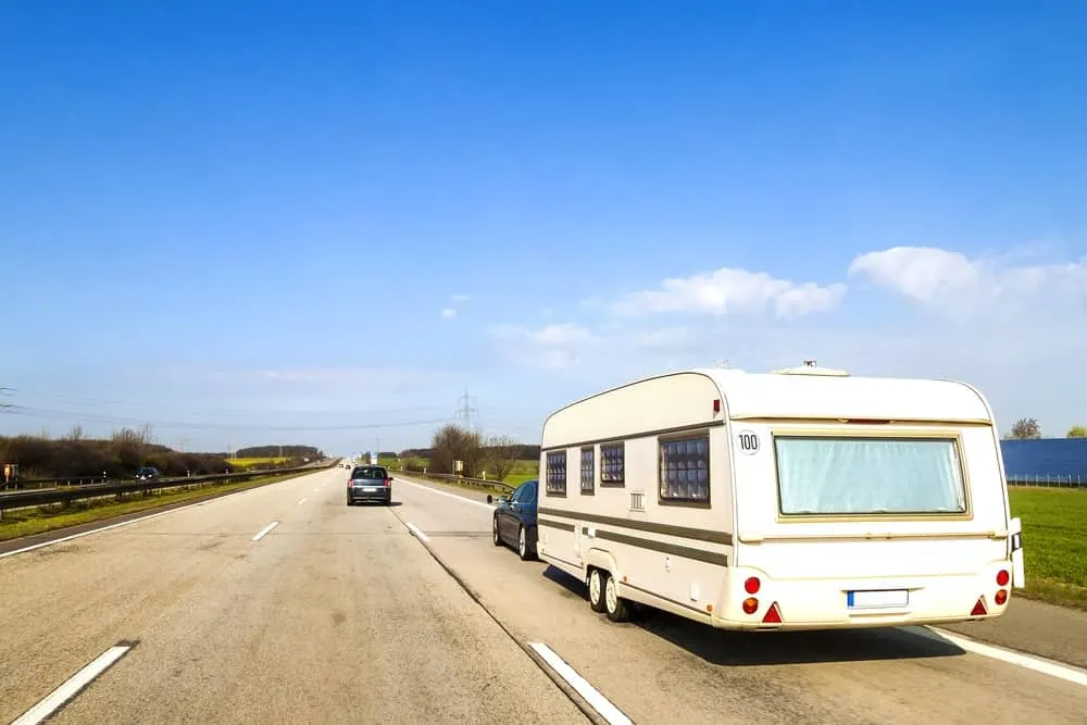 Tow-behind trailer on a freeway road.