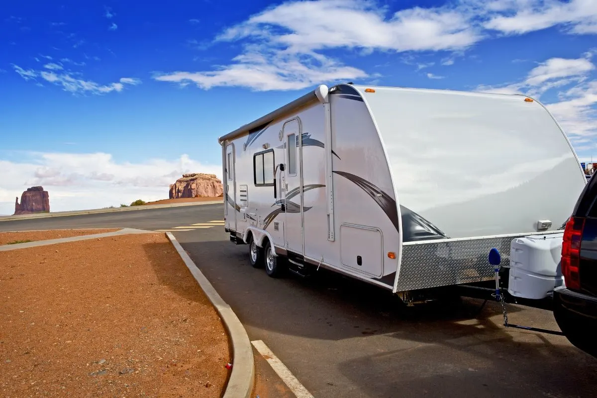 A toy hauler towed on road.