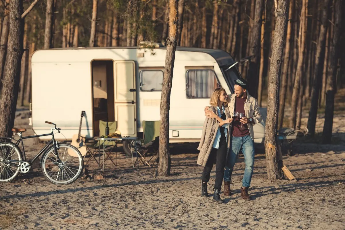 A couple walking outside a lightweight trailer.