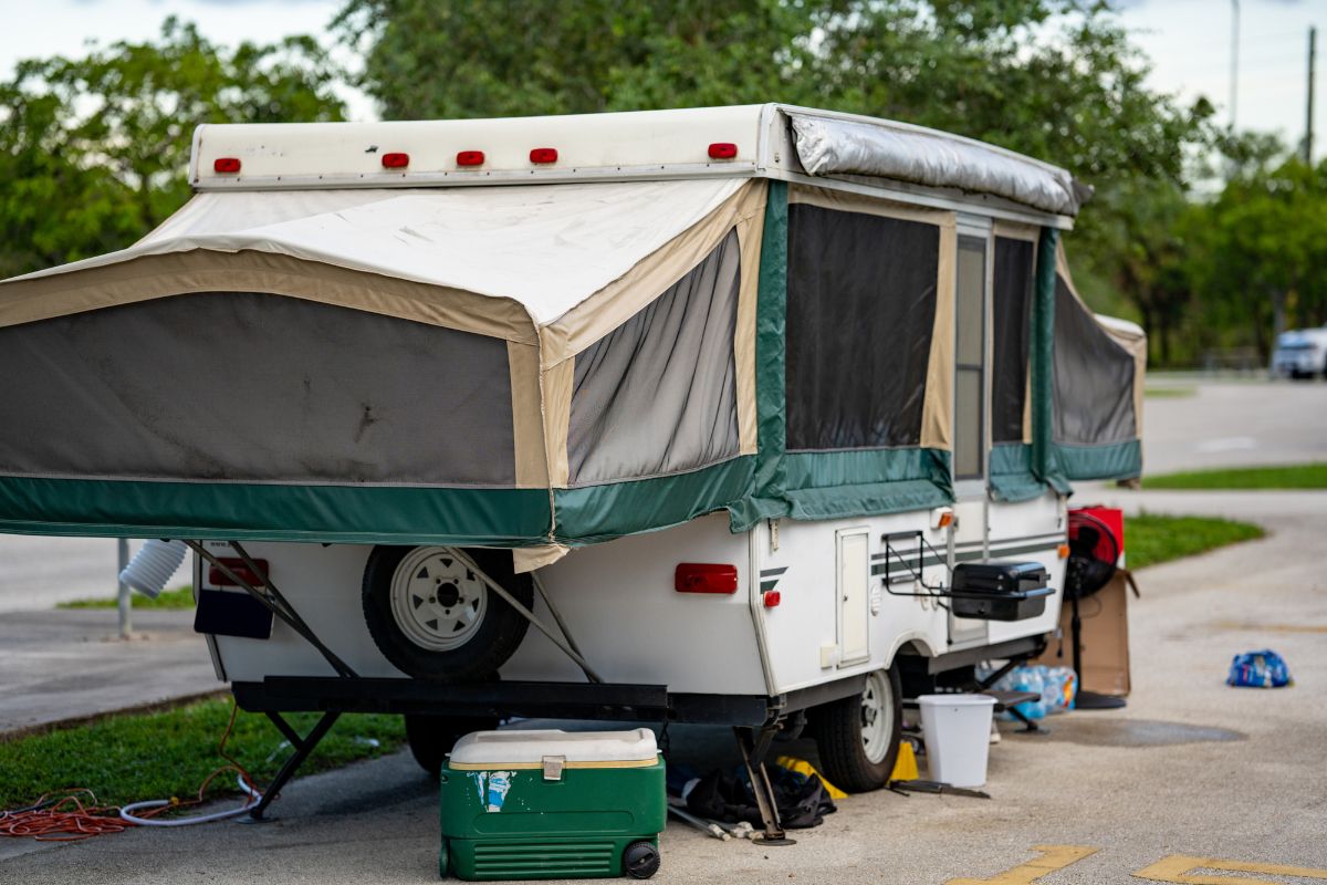 Pop-up trailer parked near on sidewalk.