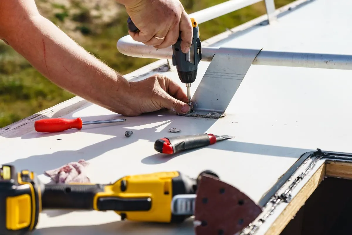 A worker installing RV roof.