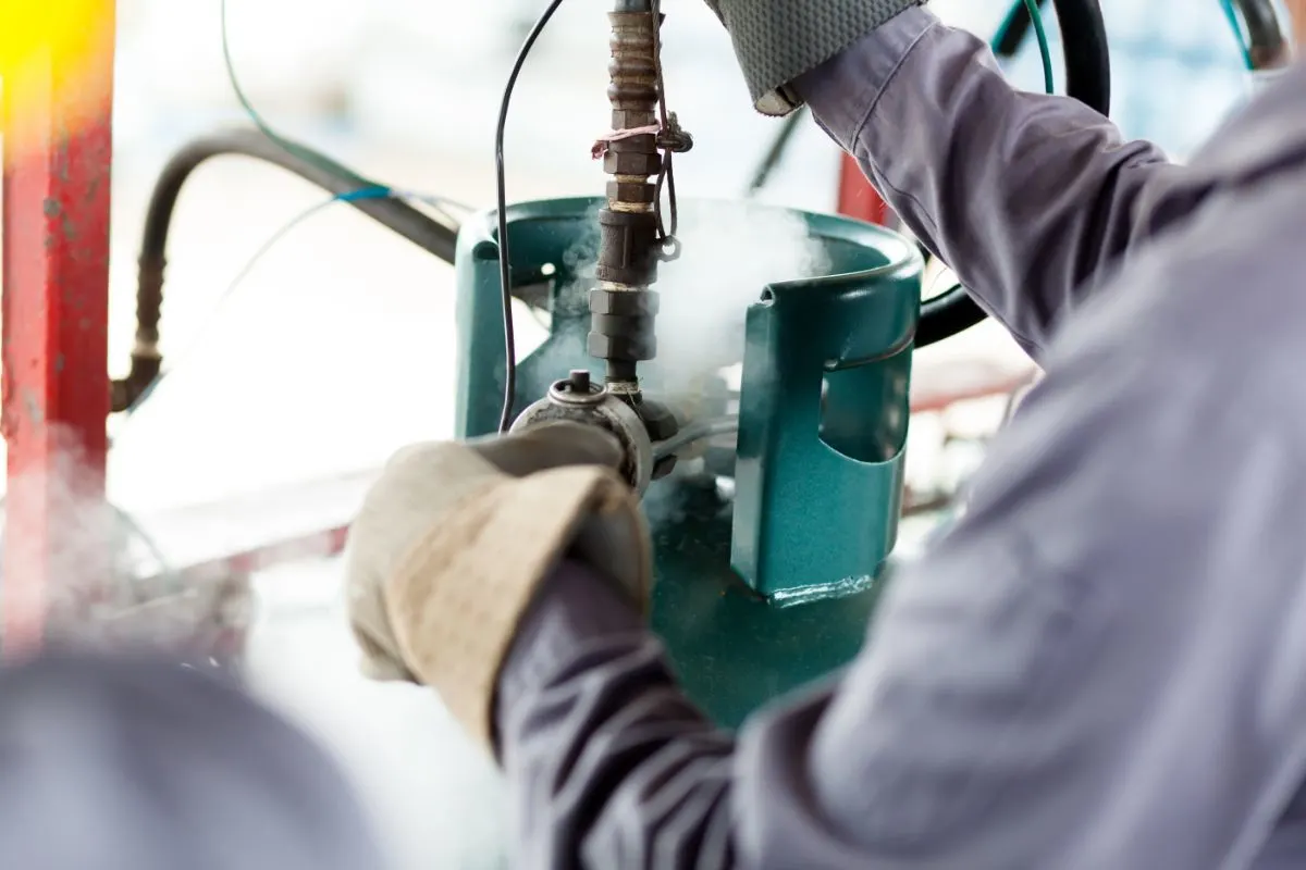 A worker working in a propane gas tank. 