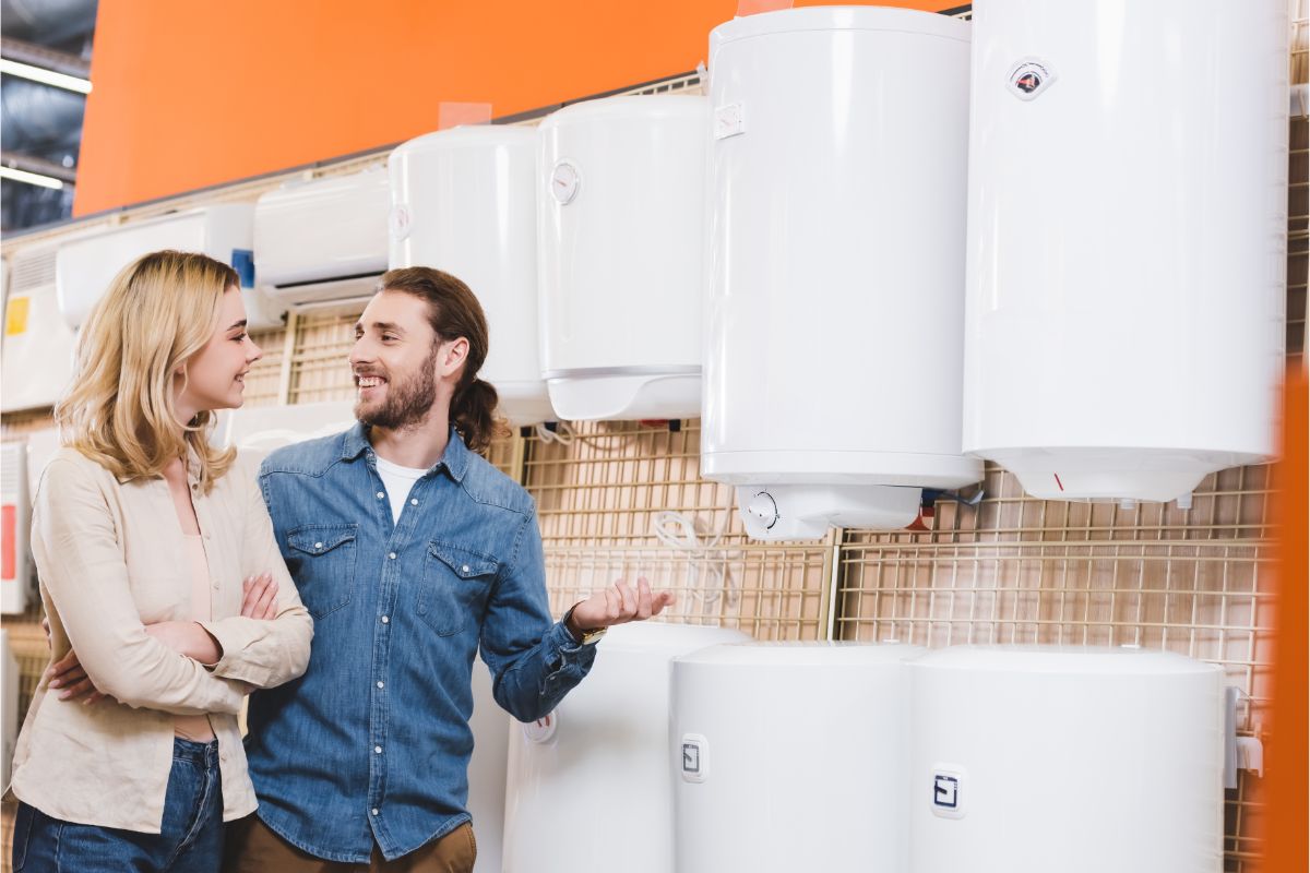 A man and woman talking at each other about the heater infront of them.