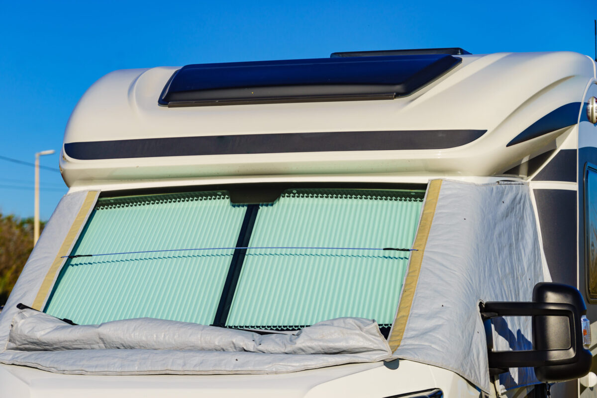 Close up photo of recreational vehicle with a material cover.