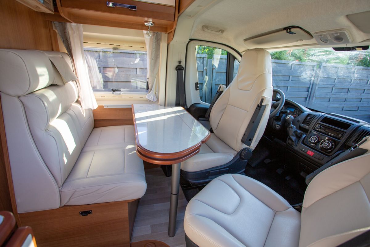 A white and neat RV interior part in the RV with the gauges and controls.