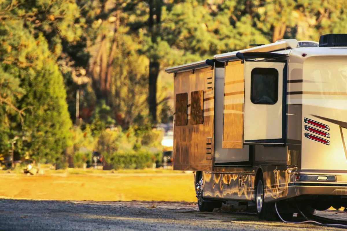 An RV parked in an open area with two extended slide-out.