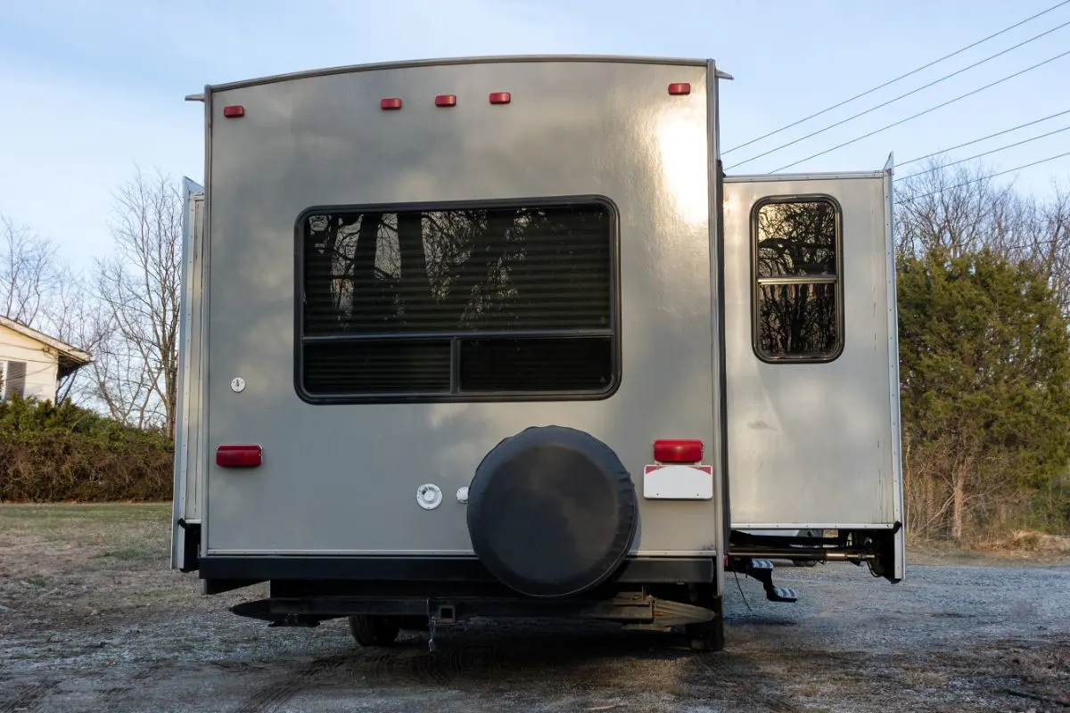 A back view of an RV with extended slide-out.