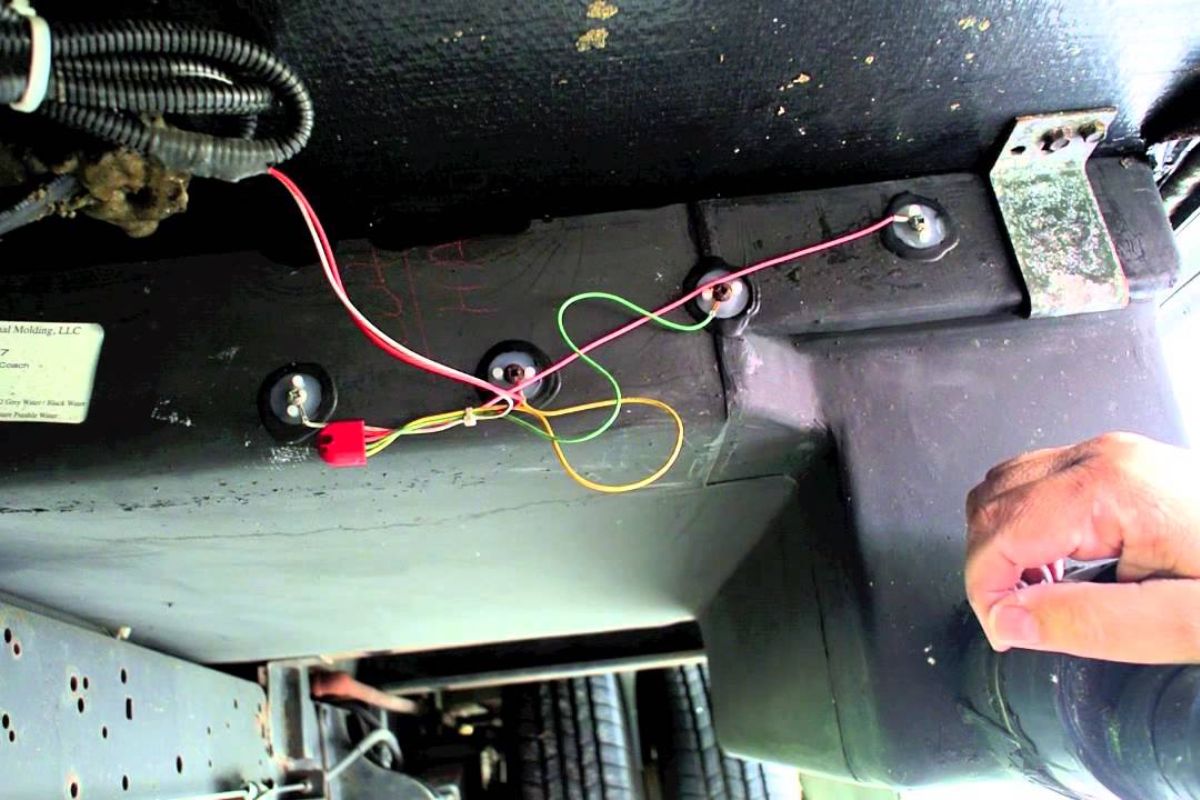 A man replacing and upgrading his RV tank sensors.