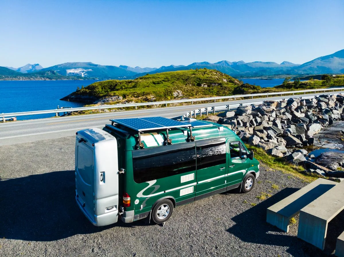 An RV on camp site with solar panel.