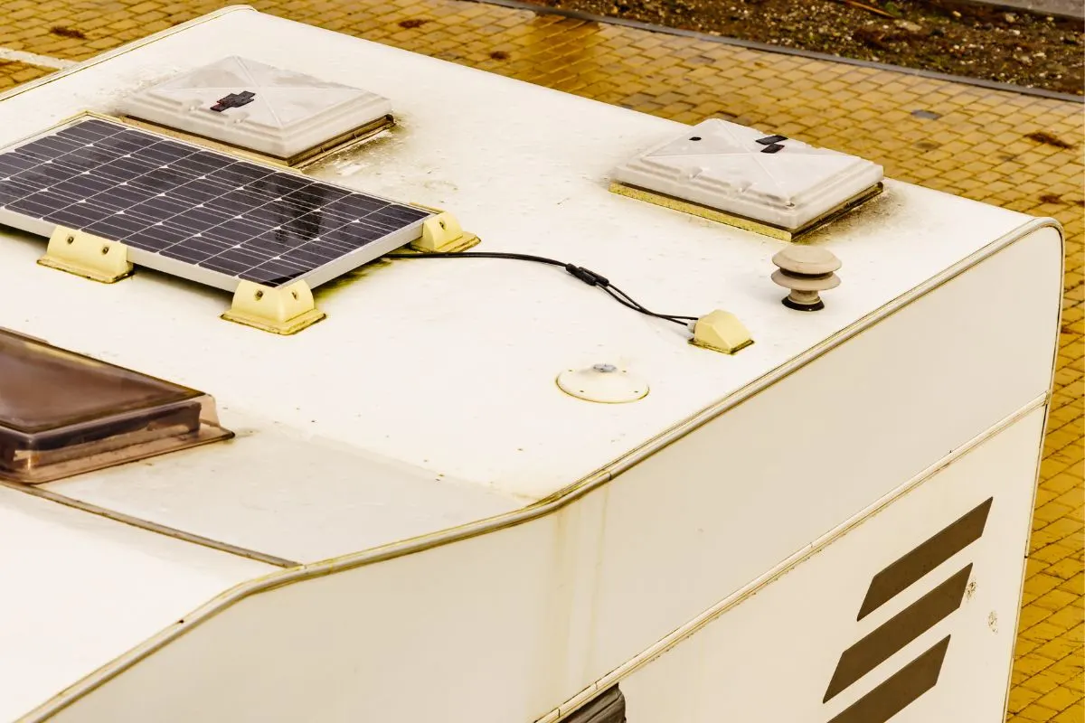 A solar photovoltaic panels, charging batteries on caravan roof.