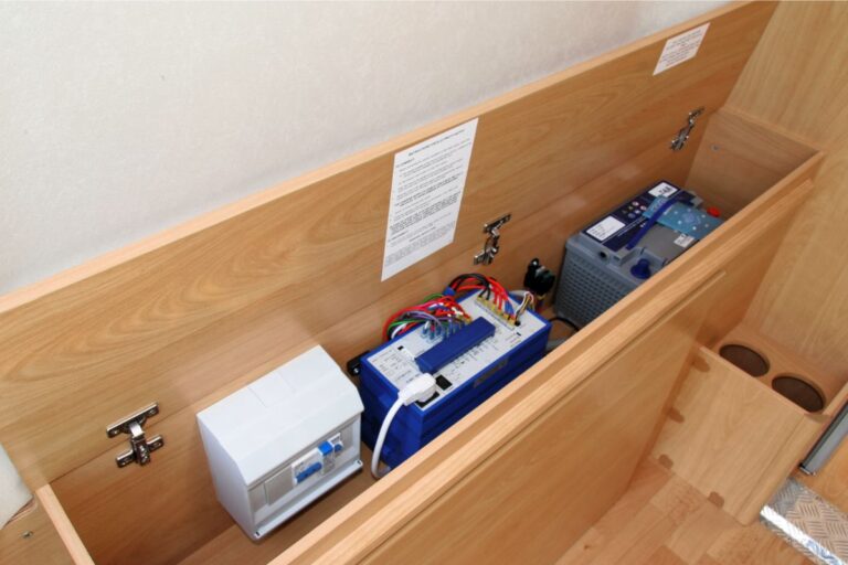 A photo of interior's van conversion motor home showing under seat mains electric box.