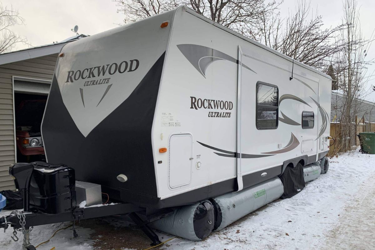 Rockwood RV parked at the snowy mountain with inflatable skirt.