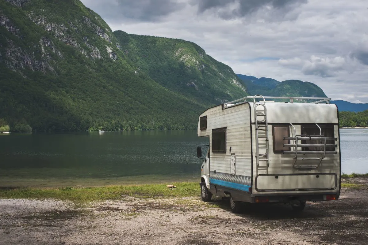 An old Class C RV near the lake.