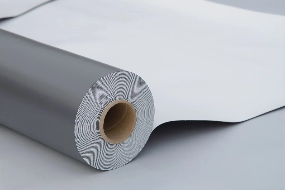 Close up photo of opened pvc membrane roll lying on roof.