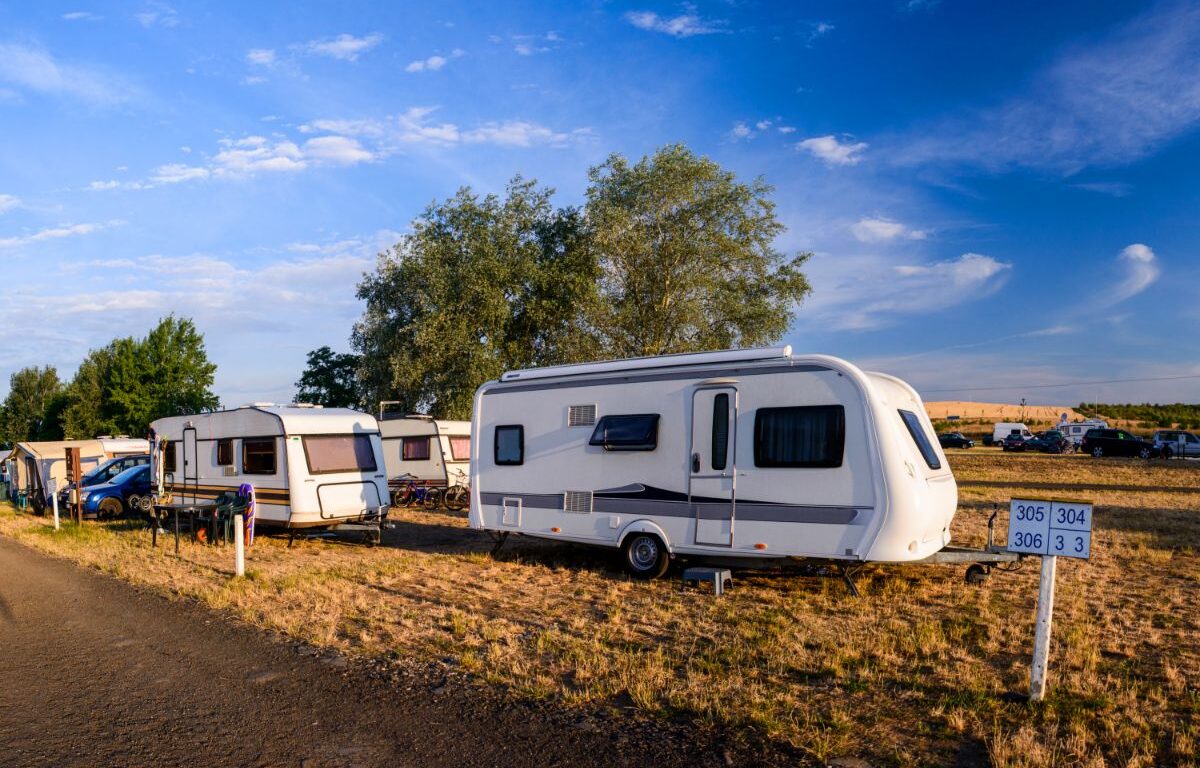 A photo of different RV parked at the side of road.