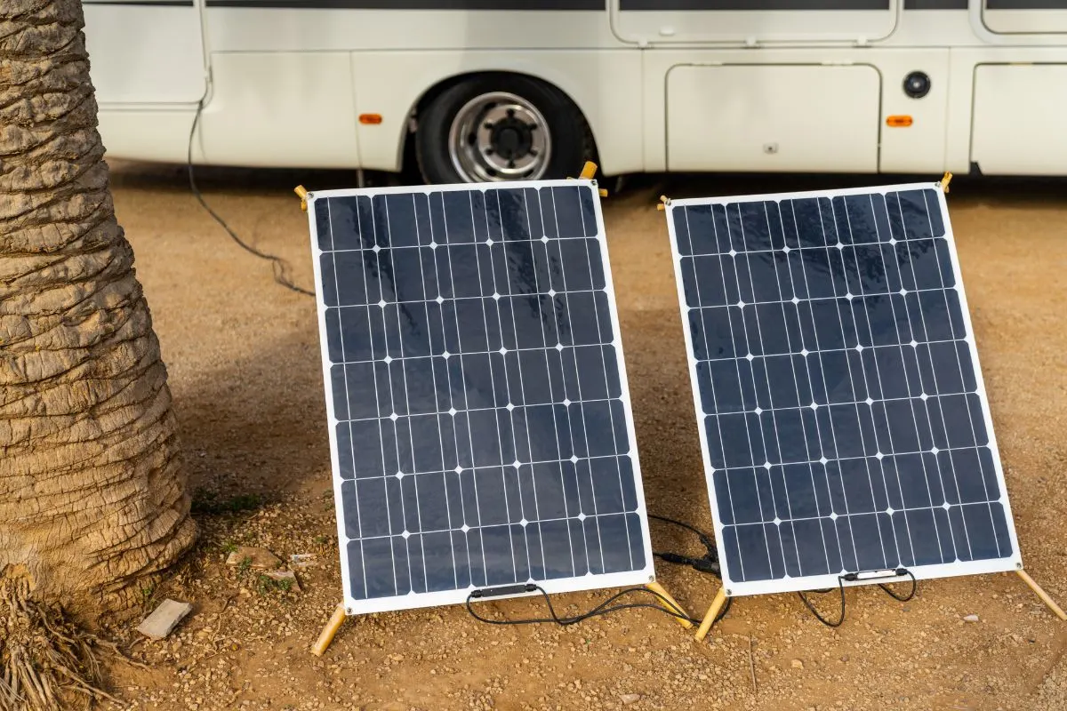 Two solar panel displayed near an RV.