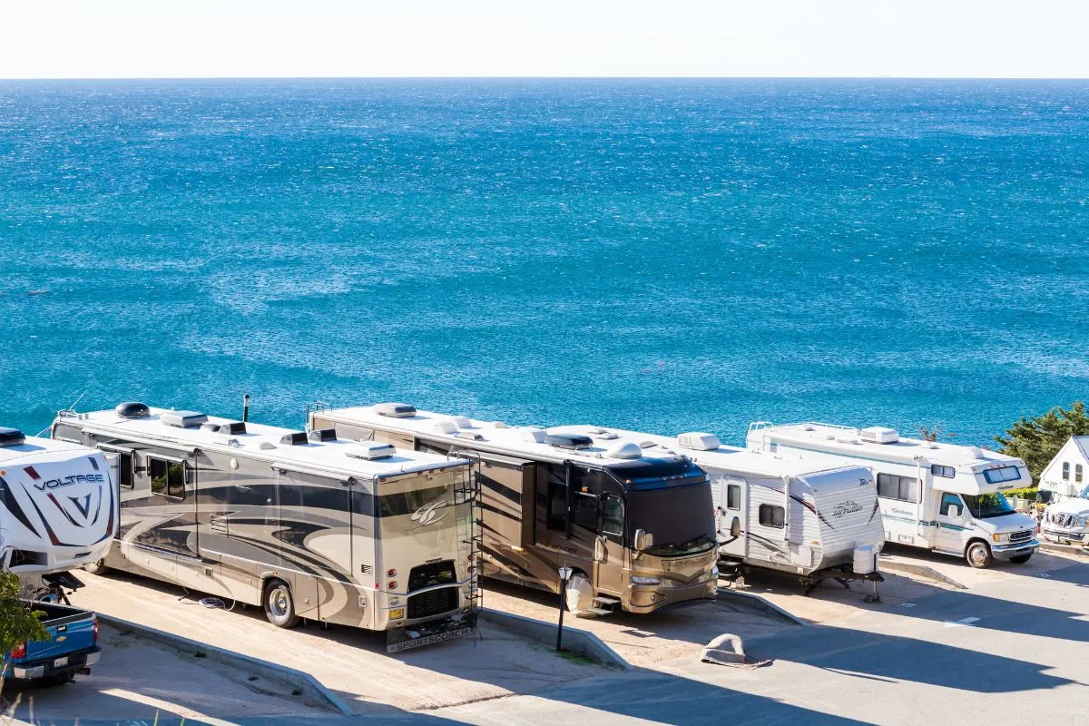 Different types of RV on sea front.