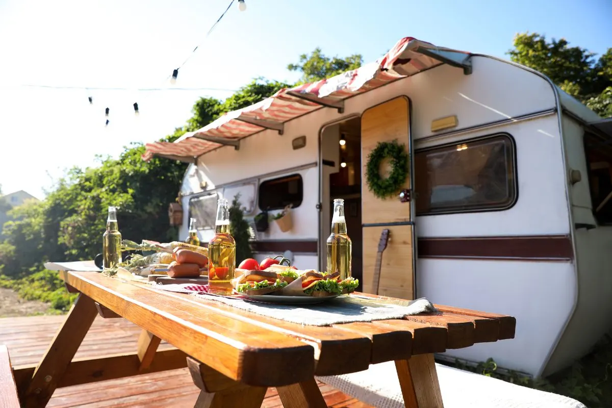 A wooden table outside an RV.