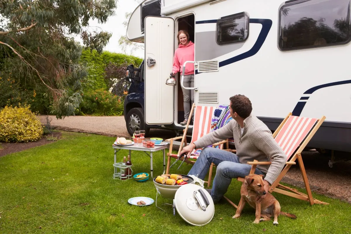 A man and woman on camping with an RV.