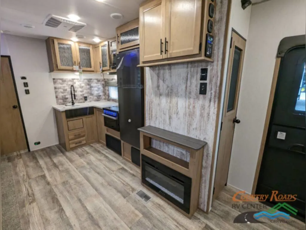 Kitchen with a sink, burner, fridge and cabinets.