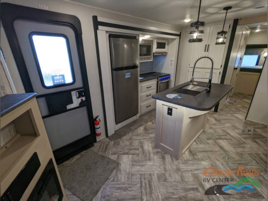 Kitchen with a fridge, gas burner and oven.