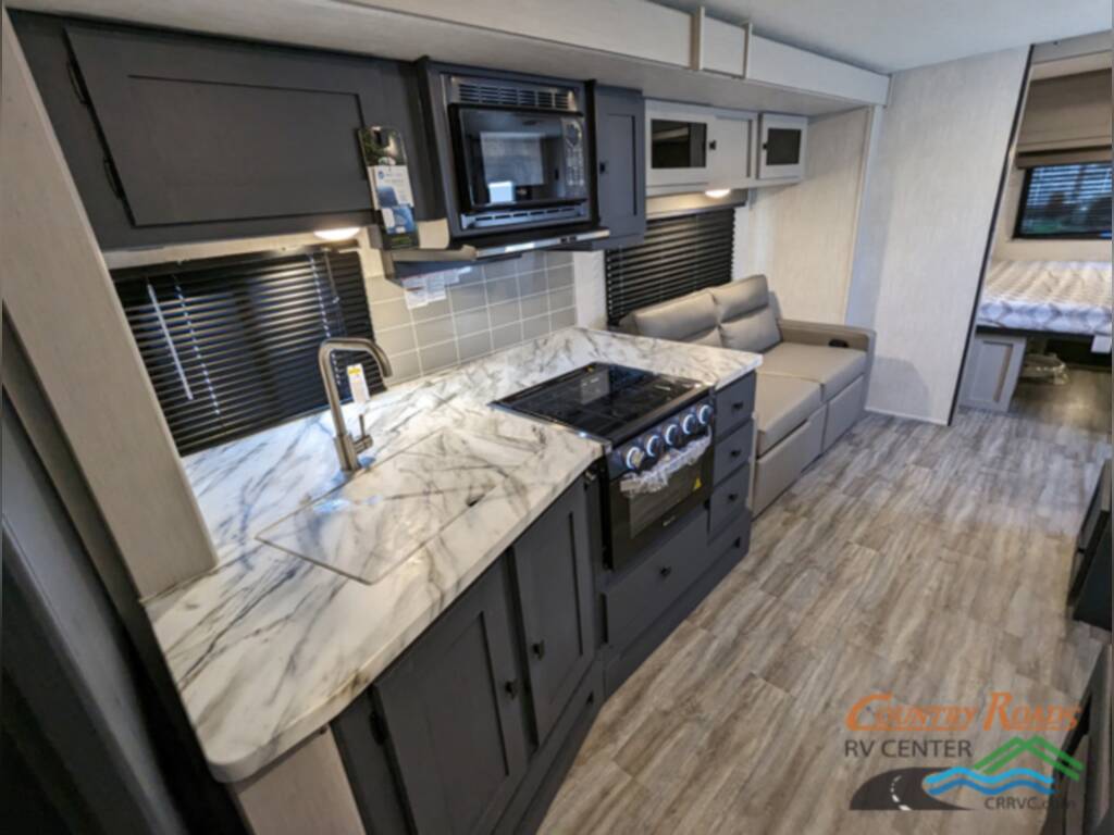 Kitchen with a sink, oven, gas burner, and cabinets.