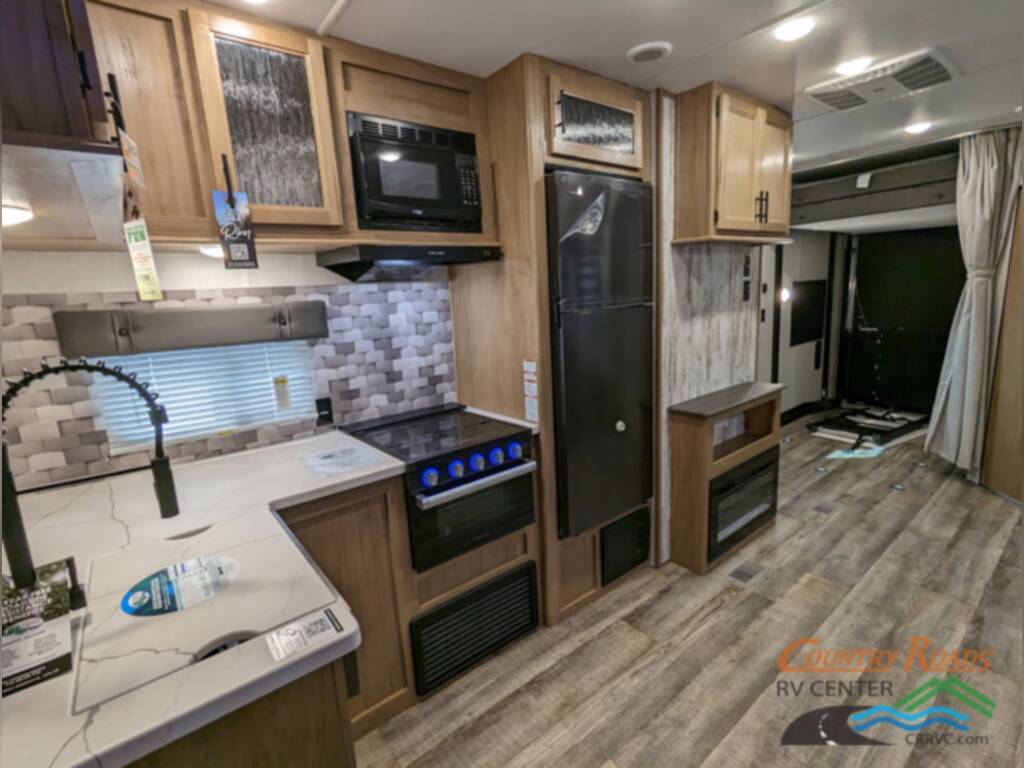 Kitchen with a sink, burner, fridge and cabinets.