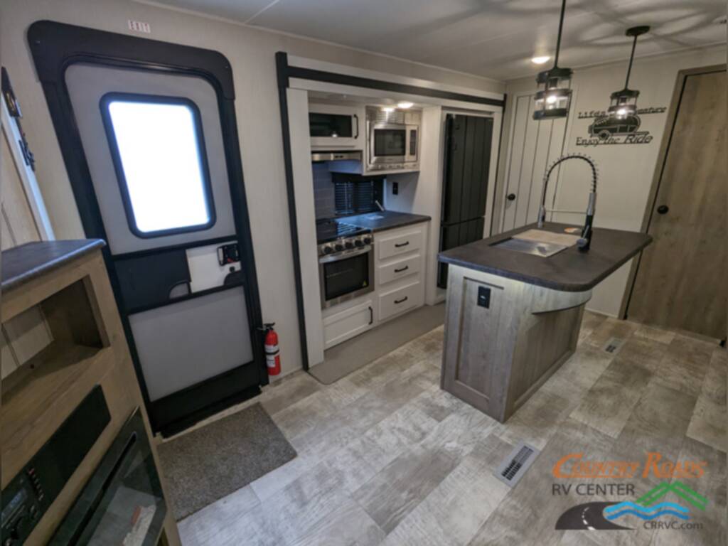 Kitchen with a sink, stainless-steel appliances and drawers.