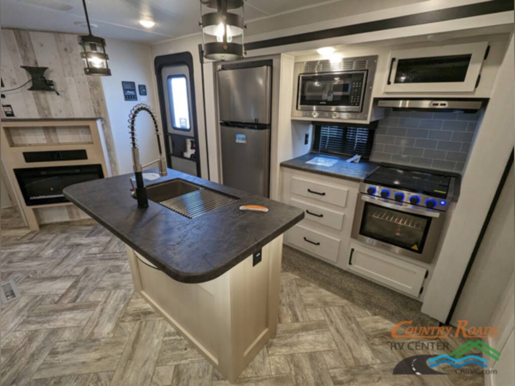 Kitchen with a fridge, gas burner and oven.