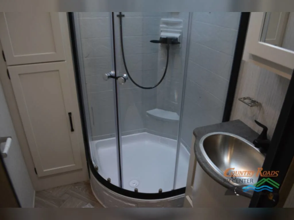 Bathroom with a sink and a shower.