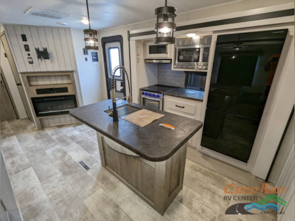 Kitchen with a sink, fridge, stainless-steel appliances and drawers.