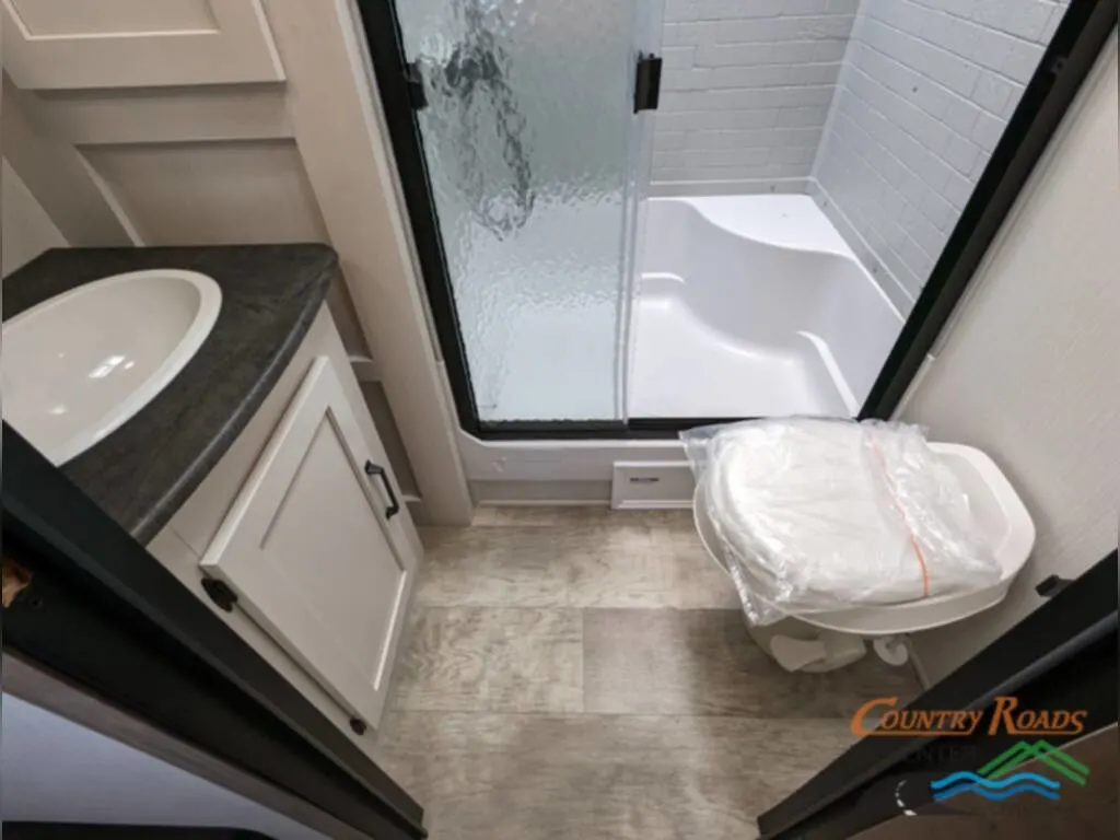 Bathroom with a sink, toilet and a walk-in shower.