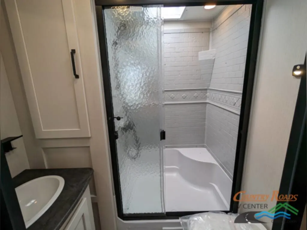 Bathroom with a sink and a walk-in shower.