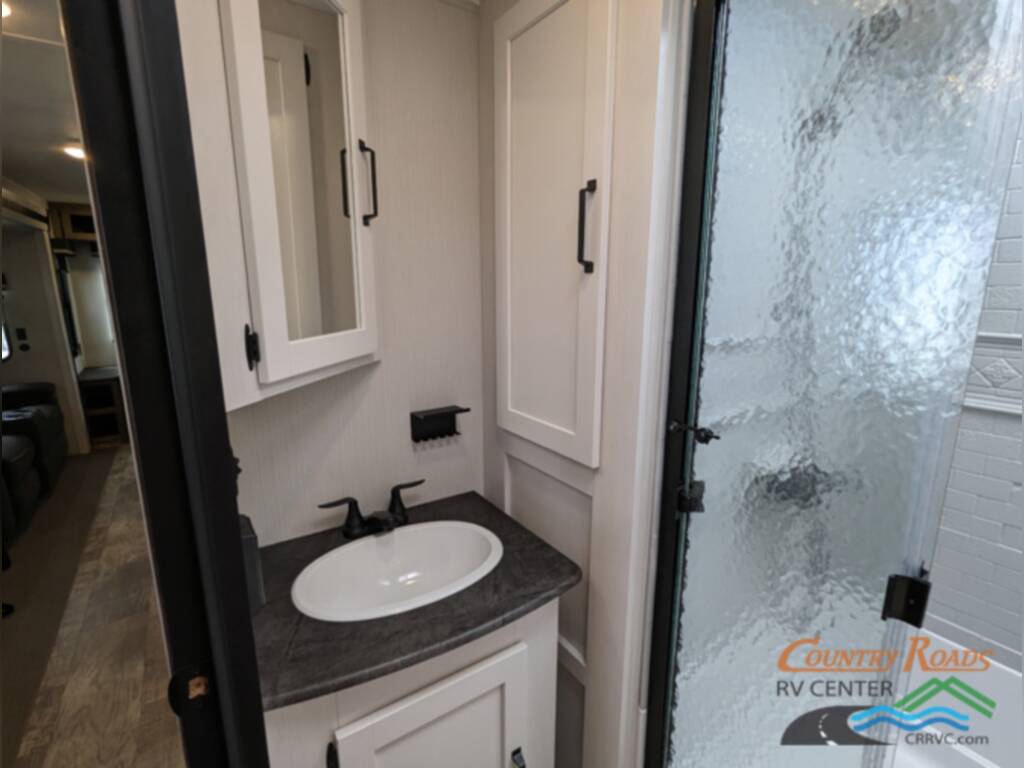 Bathroom with a sink and a walk-in shower.